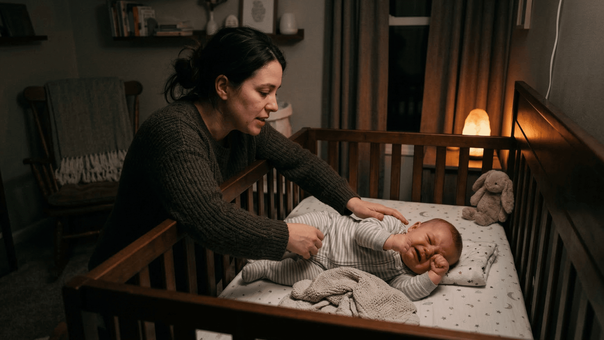 baby fighting sleep in crib while looking tired and fussy at bedtime