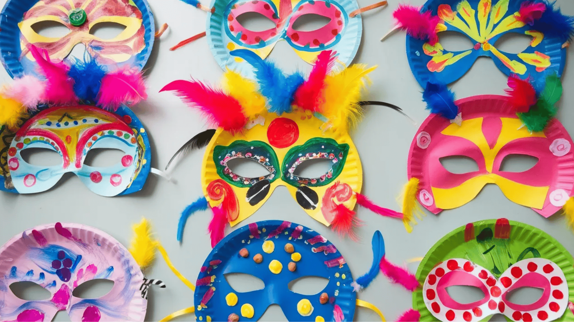 colorful paper plate masks decorated with paint, feathers, and craft supplies arranged on a table for a kids craft activity