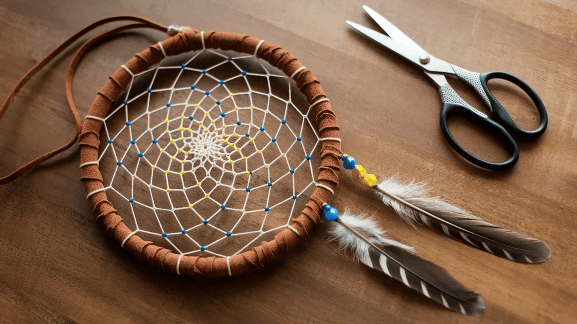 diy dreamcatcher with two feathers hanging