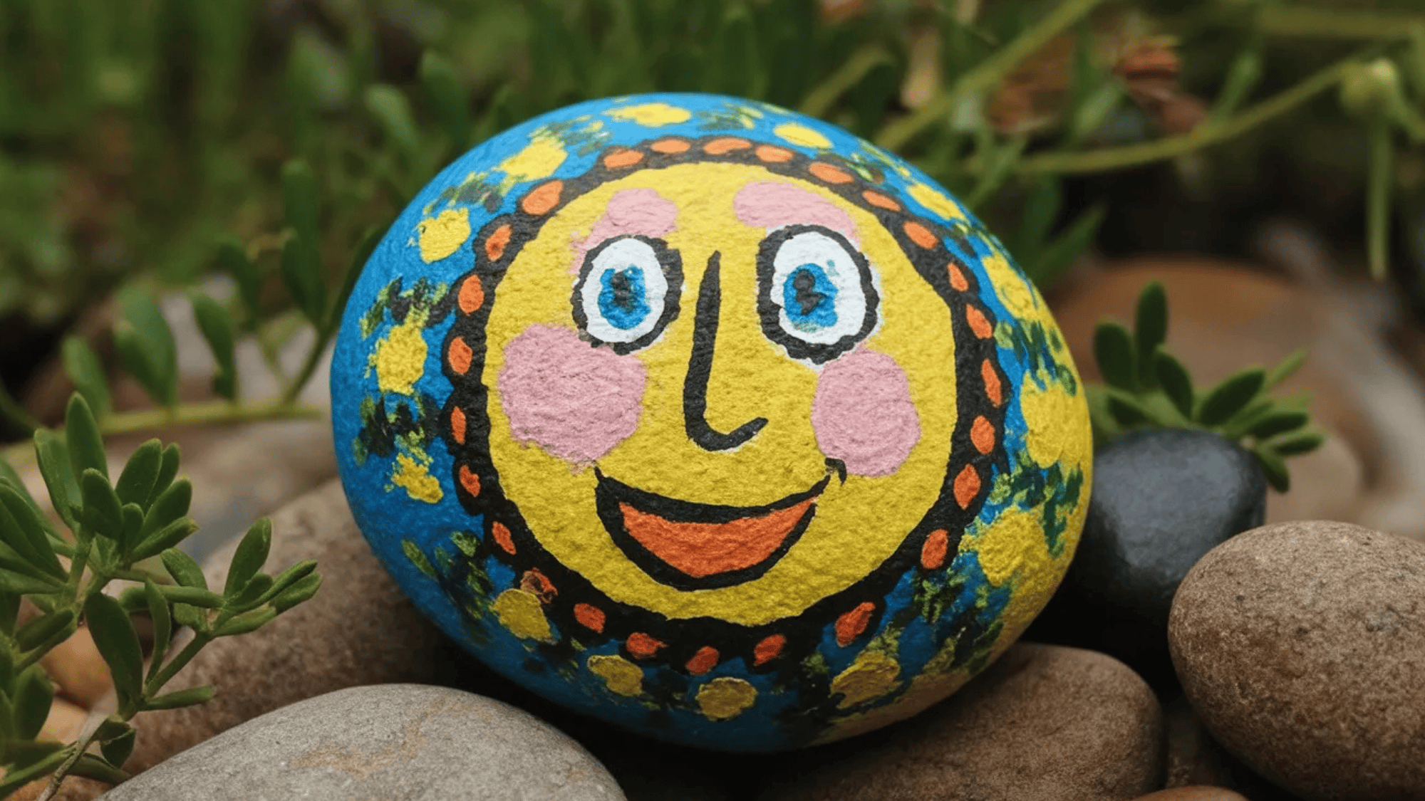 diy rock painting os a smiling face