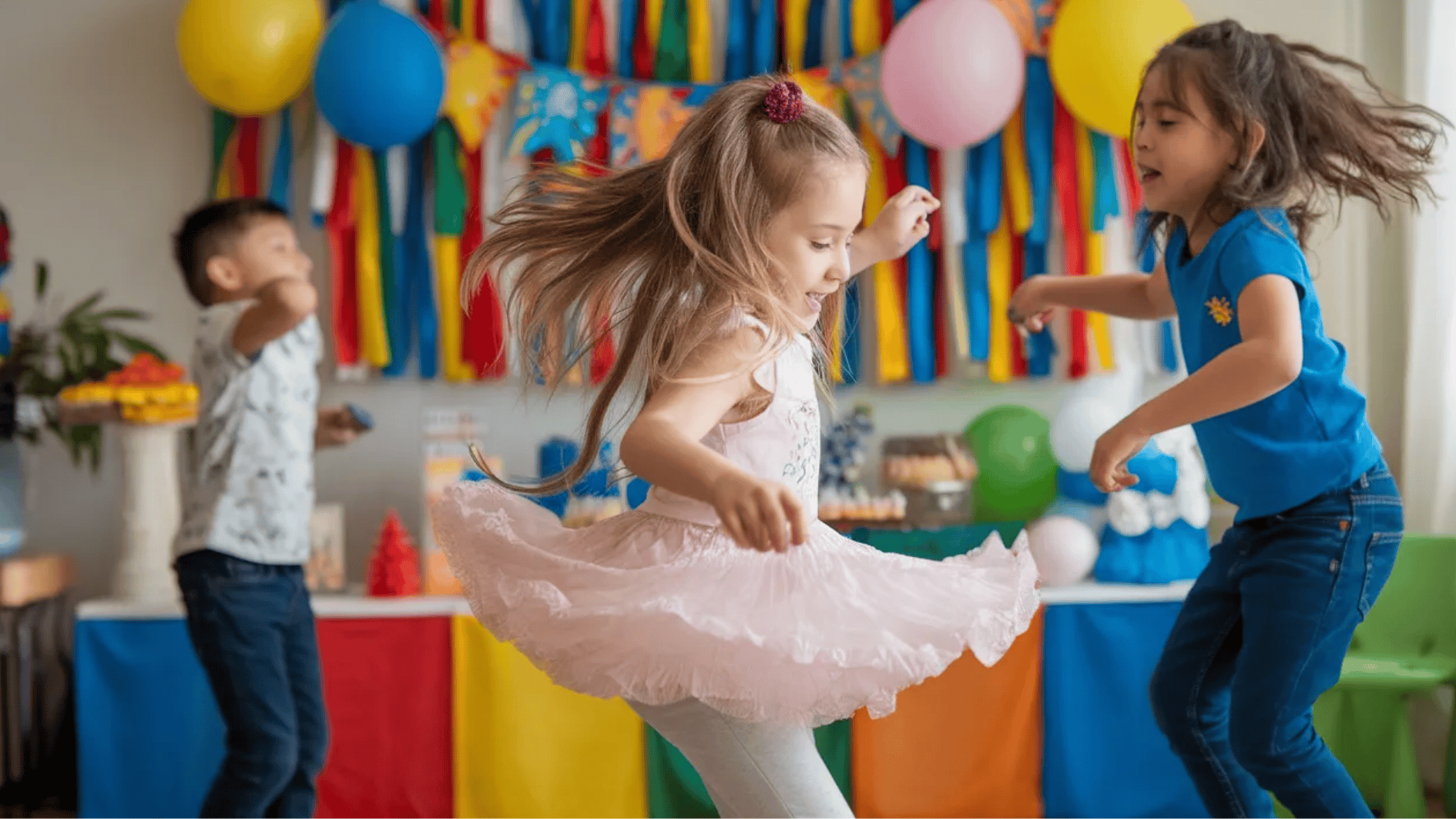 kids dancing and having fun at a colorful home party with balloons, streamers, and festive decorations