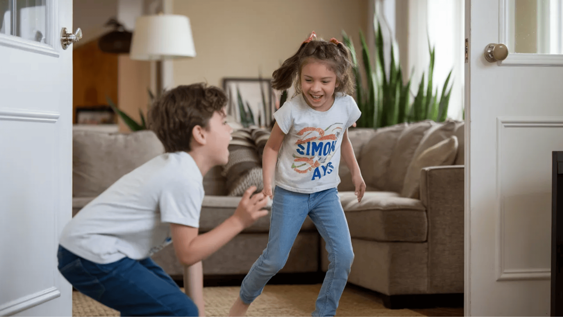 kids playing the Simon Says movement game in a living room, laughing and following the instructions while having fun