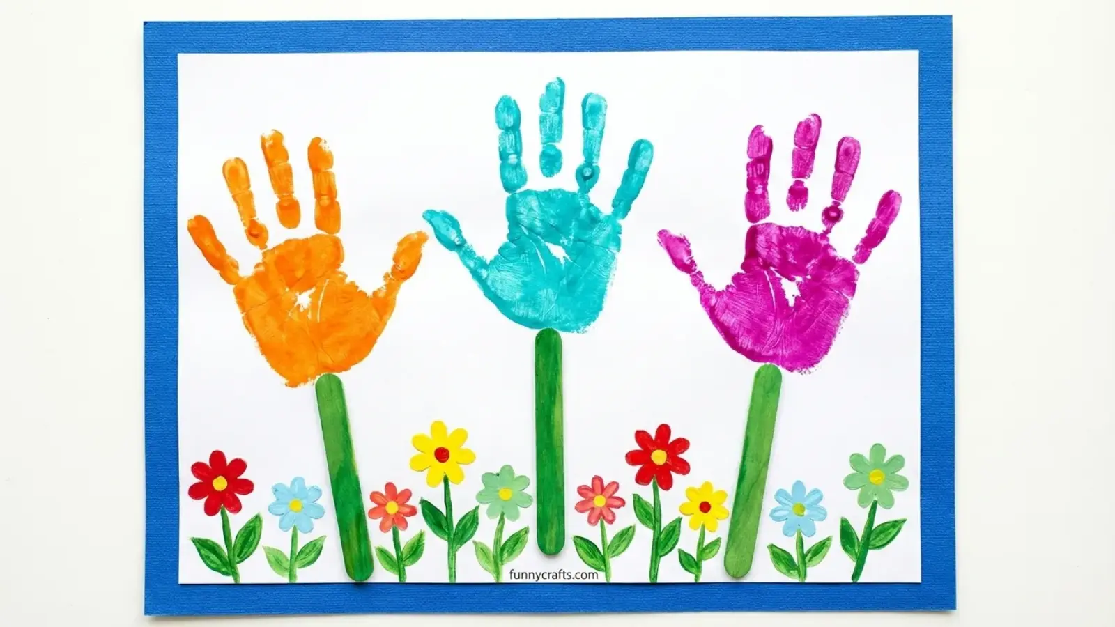 Colorful handprint flowers with painted stems and small flowers on paper