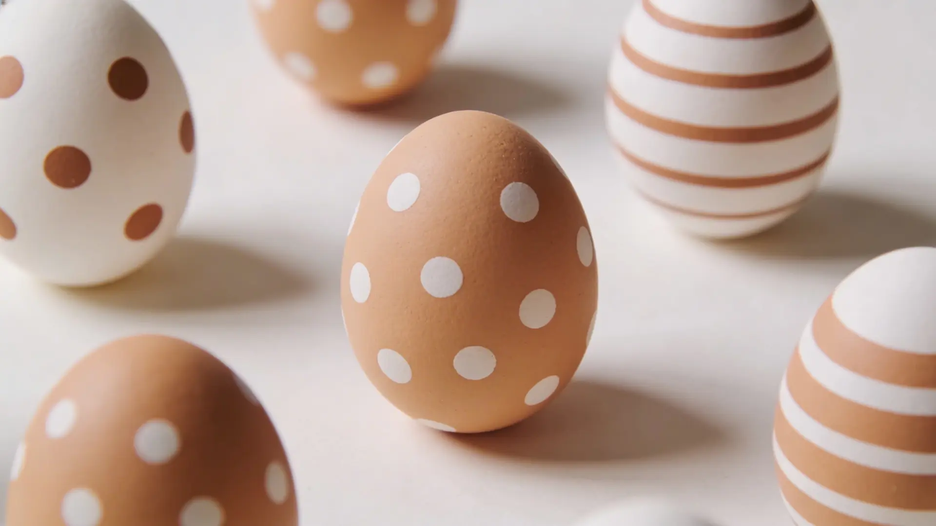 Eggs painted with dots, stripes, and simple color patterns