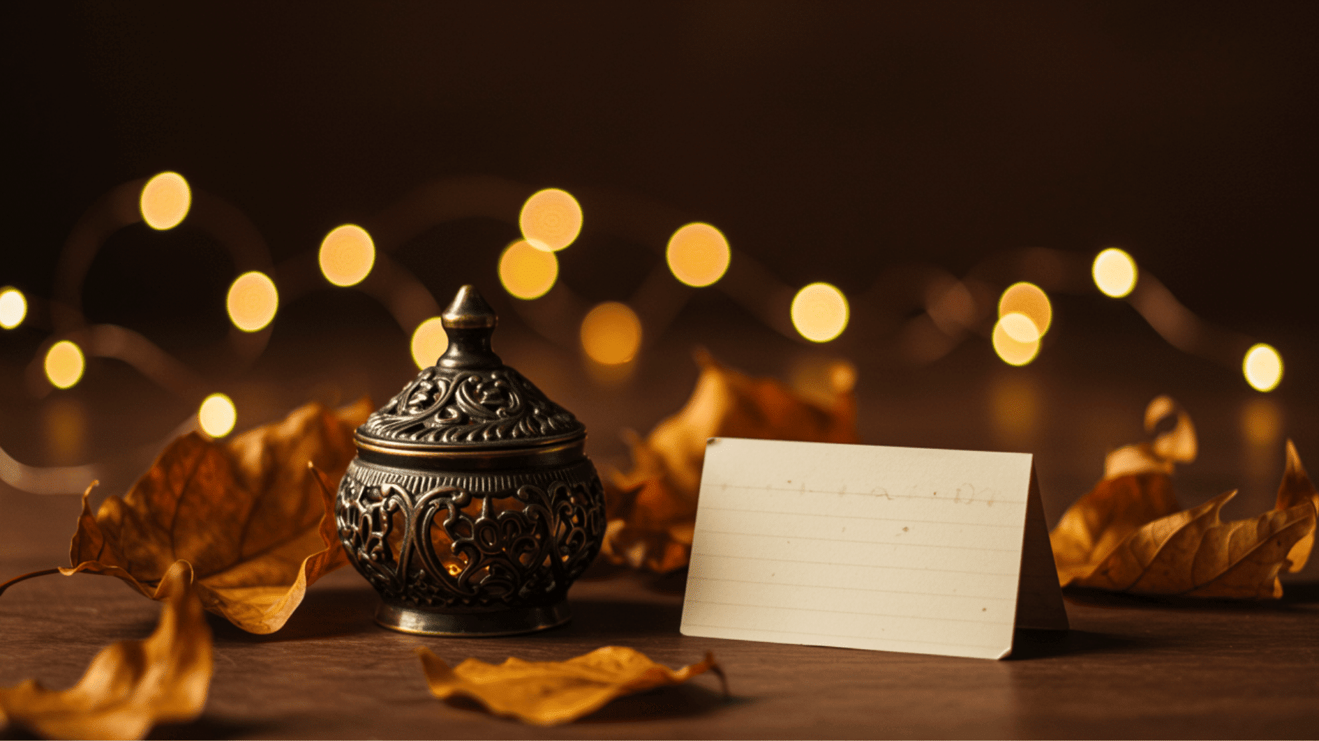 decorative jar with blank name card, autumn leaves, and warm string lights creating a cozy thanksgiving table setting