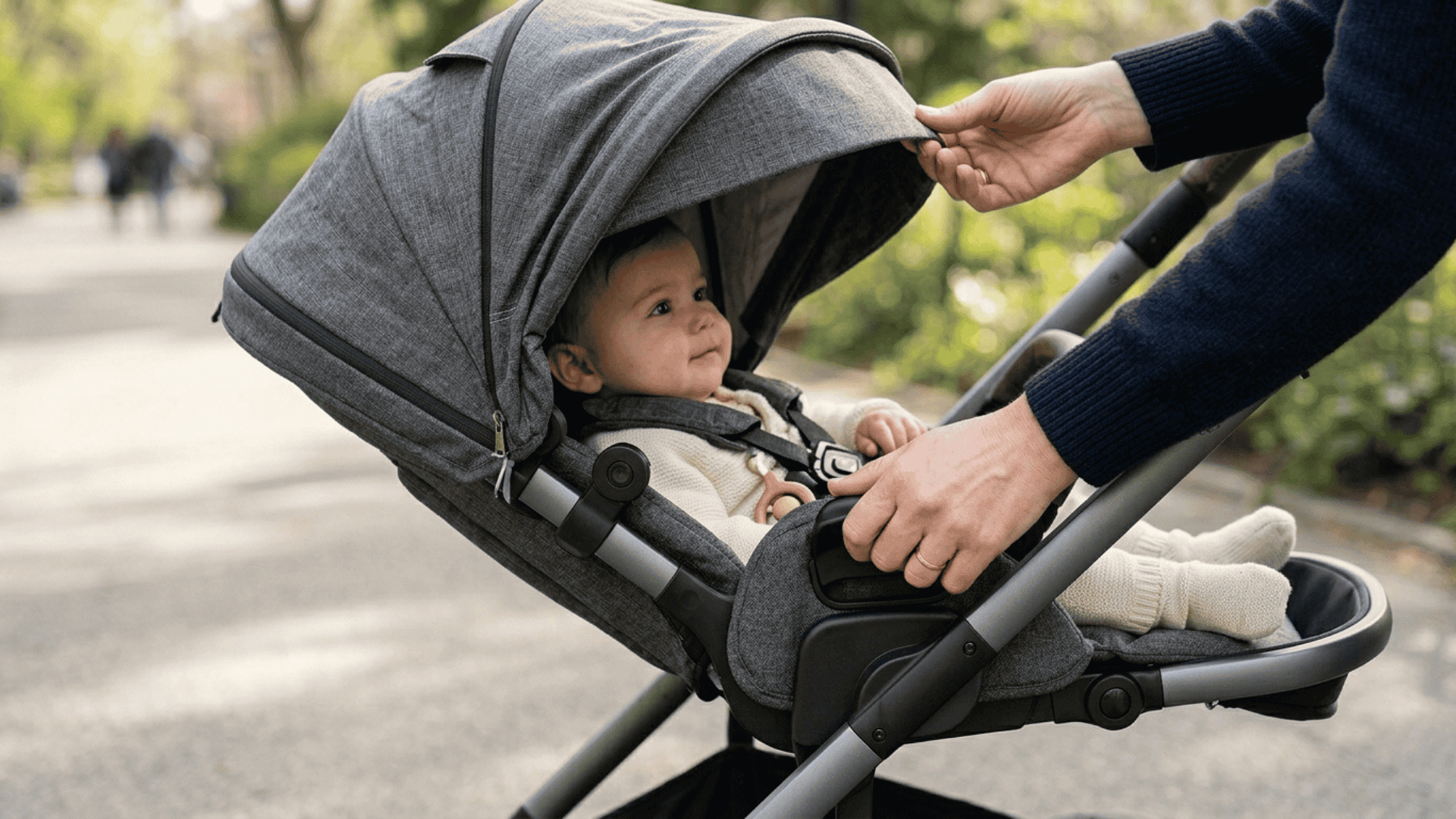 hands adjusting stroller reclining seat and canopy showing comfort features with smooth structure and soft lighting in clean setup