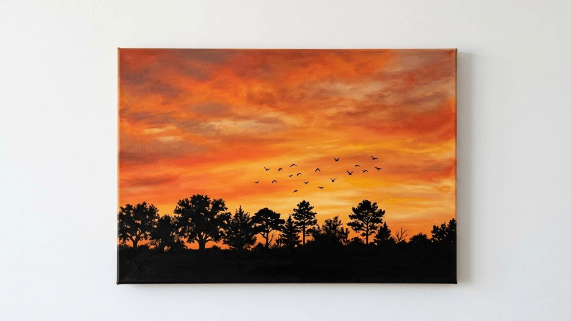 silhouette sunset painting on a front facing canvas with warm orange red and yellow gradient and black tree silhouettes
