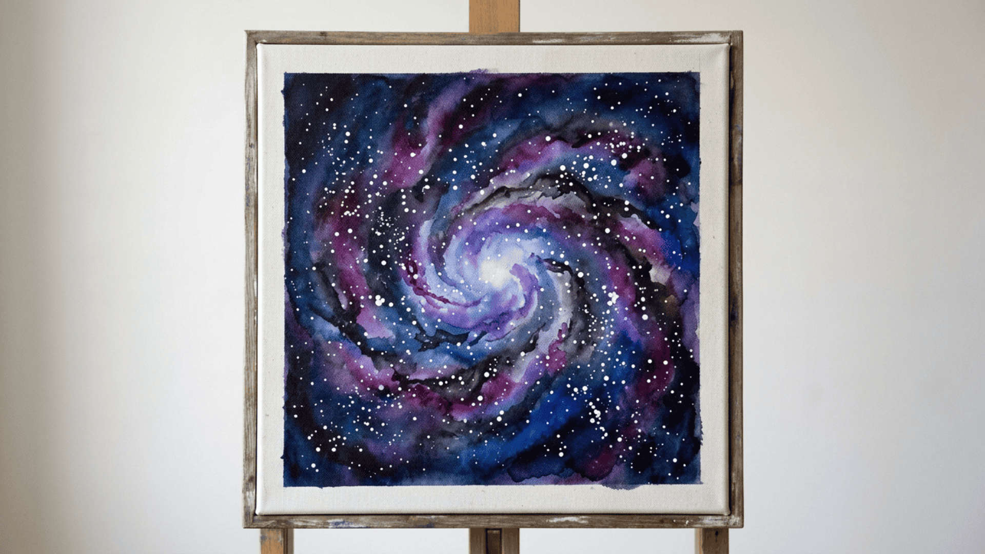 watercolor galaxy painting with blended purple blue and black tones and scattered white star dots on canvas