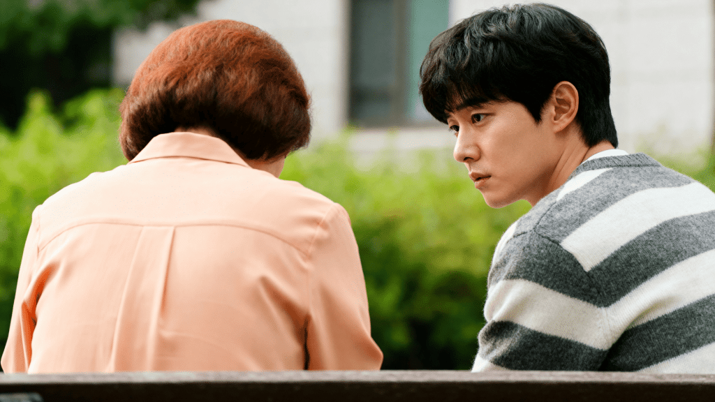 young man looks concerned while sitting with older person outdoors, reflecting generational tension and need for personal boundaries