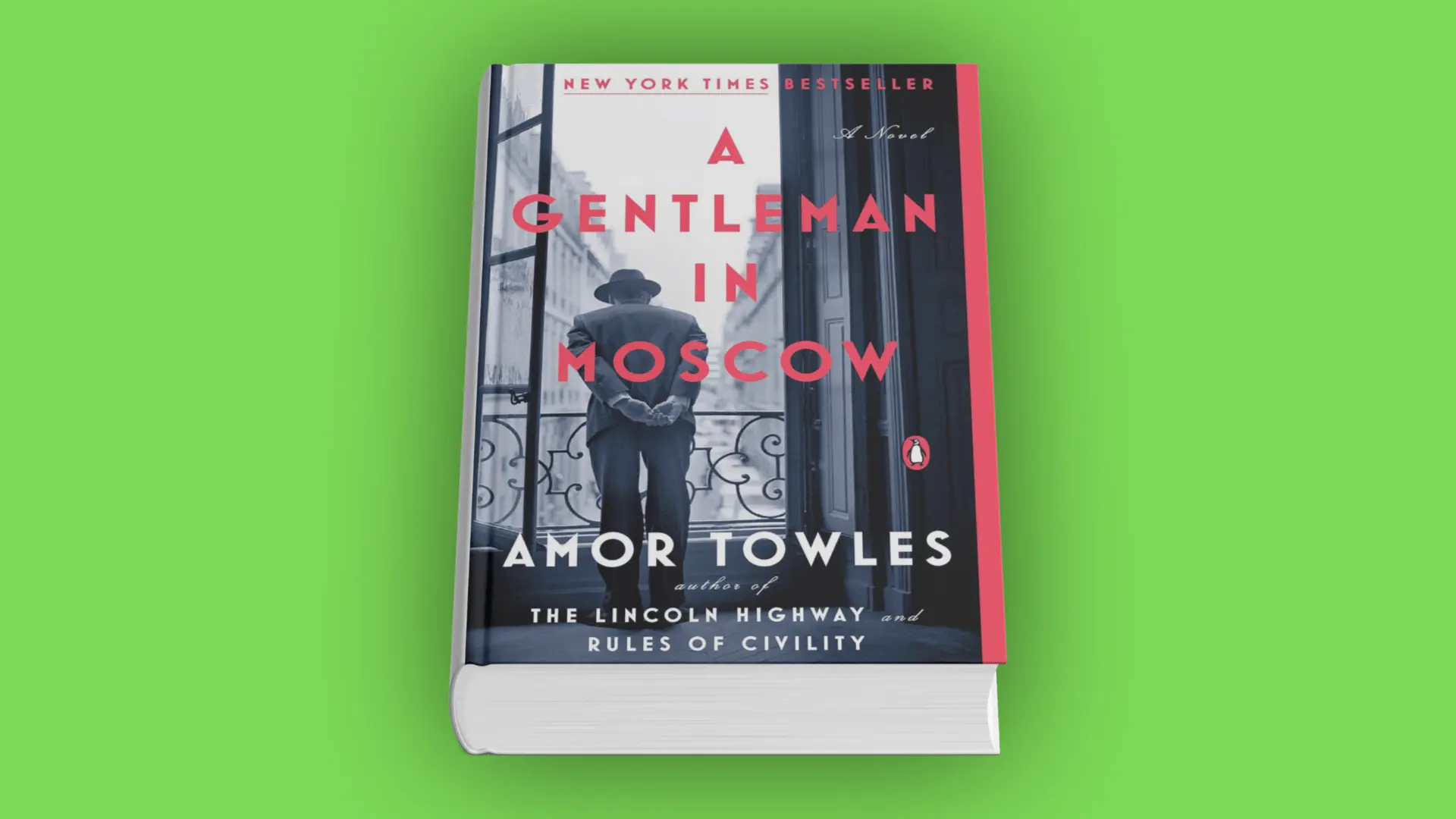 Book cover of A Gentleman in Moscow by Amor Towles with a man in a suit and hat standing on a balcony overlooking a city