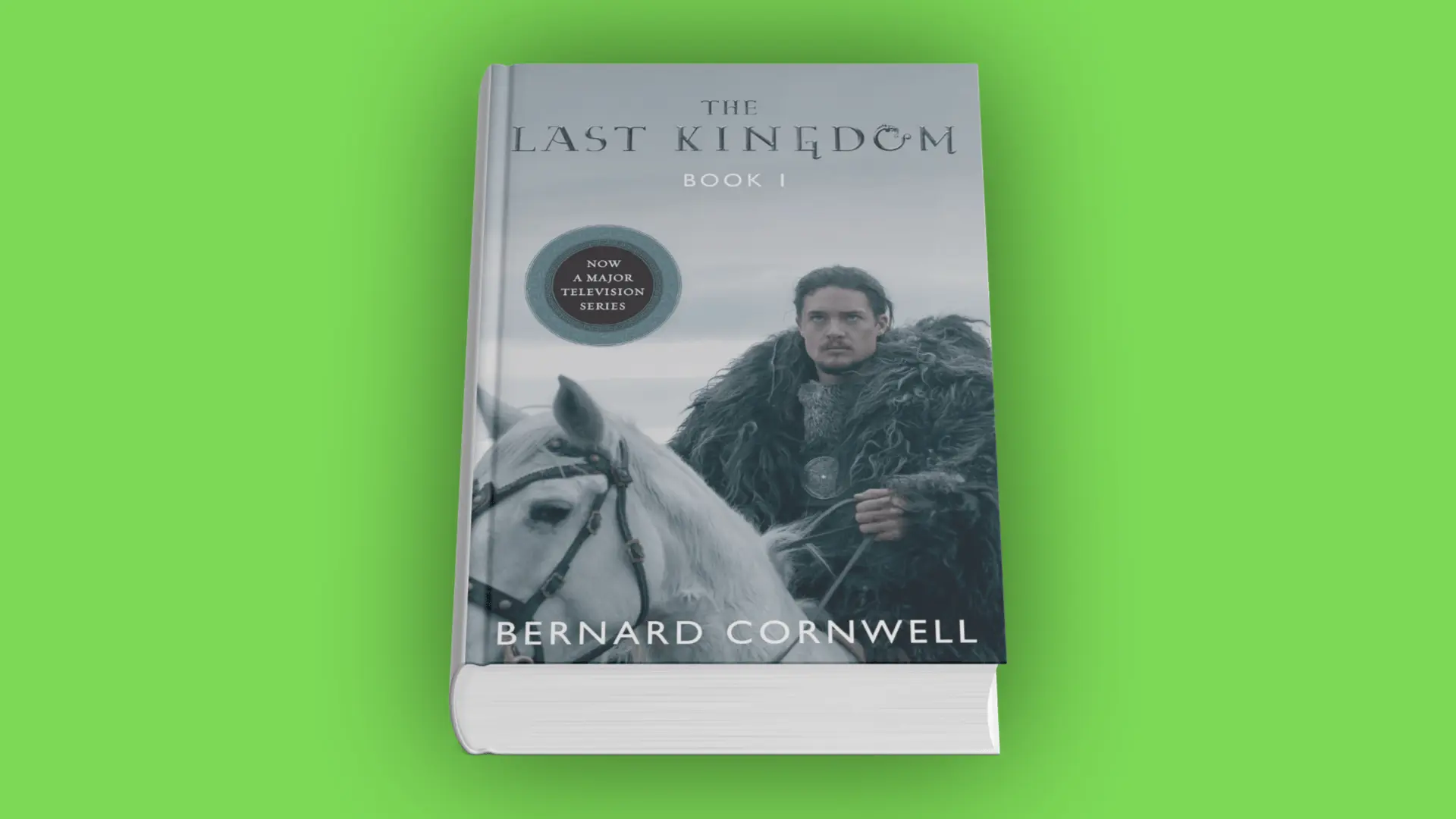 Book cover of The Last Kingdom by Bernard Cornwell with a warrior in fur cloak riding a white horse