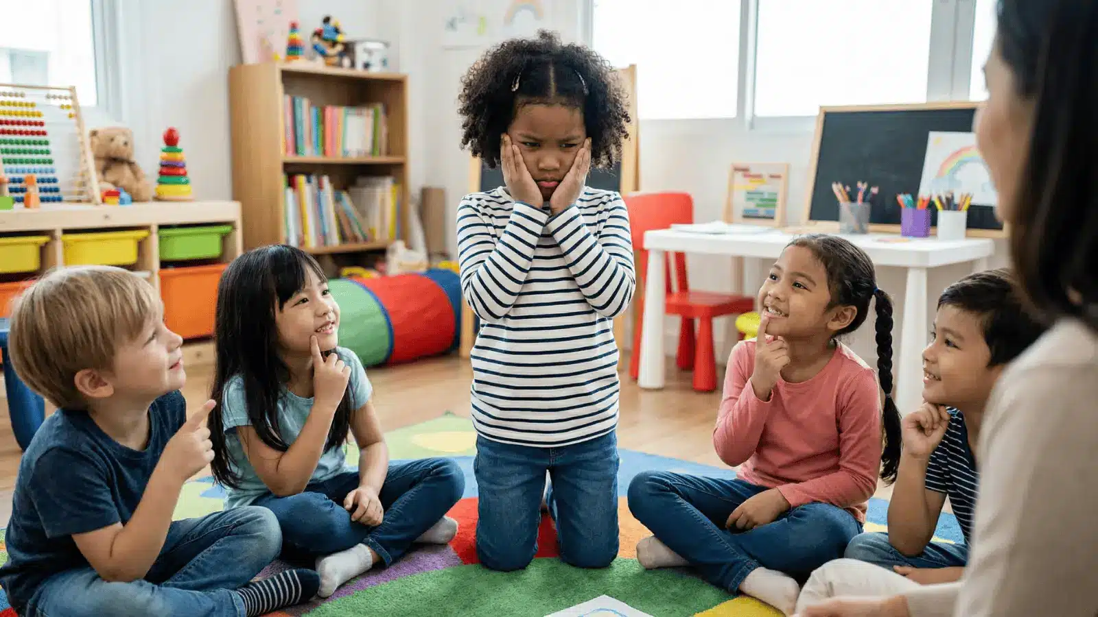 Children acting out feelings while others watch and guess in a group setting