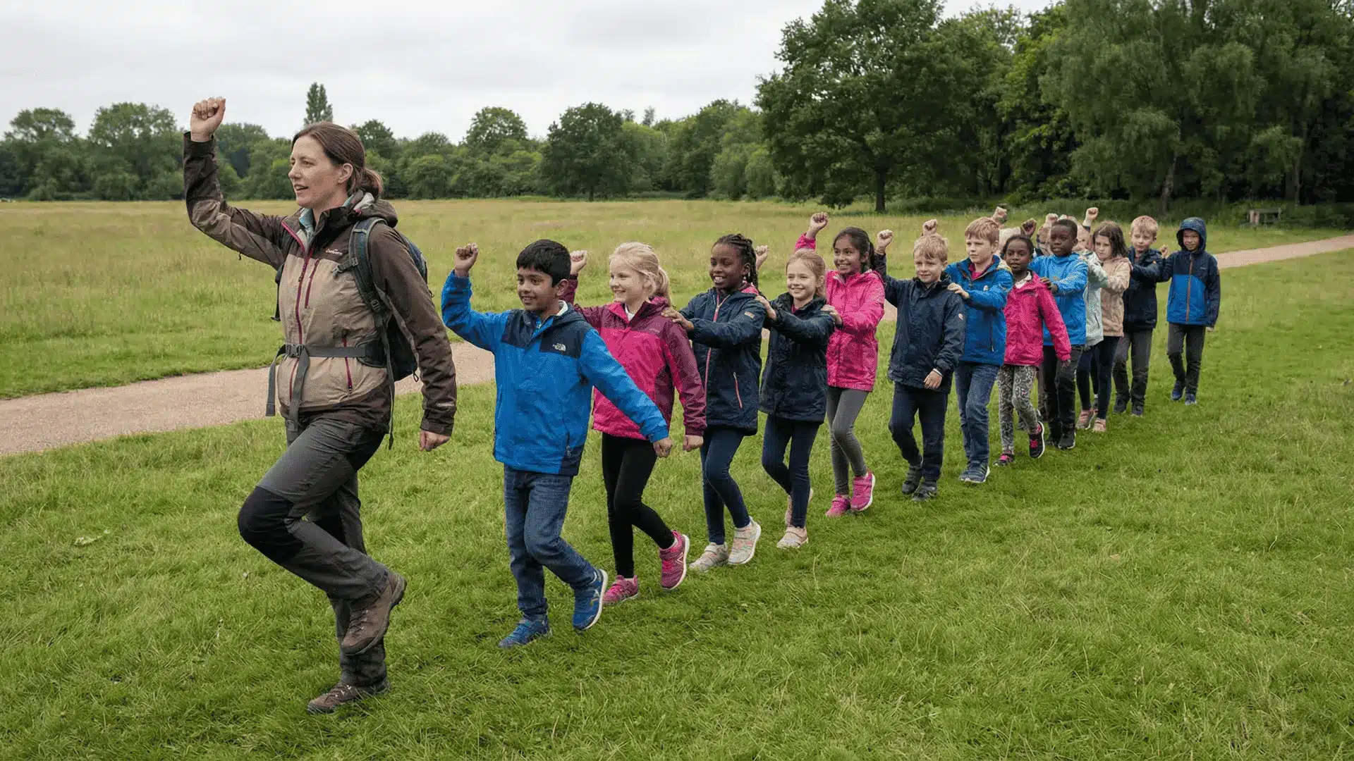 Children following a leader in a line while copying movements
