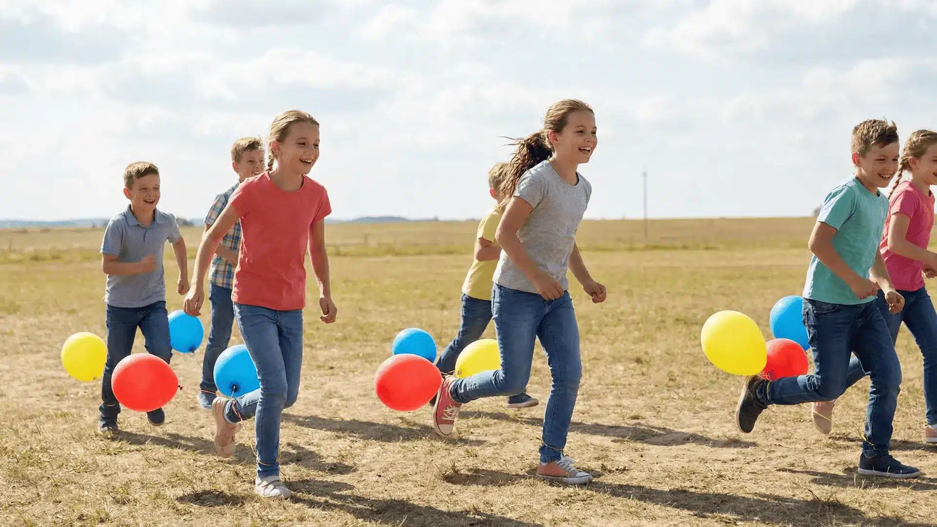 Children moving with balloons tied to their ankles