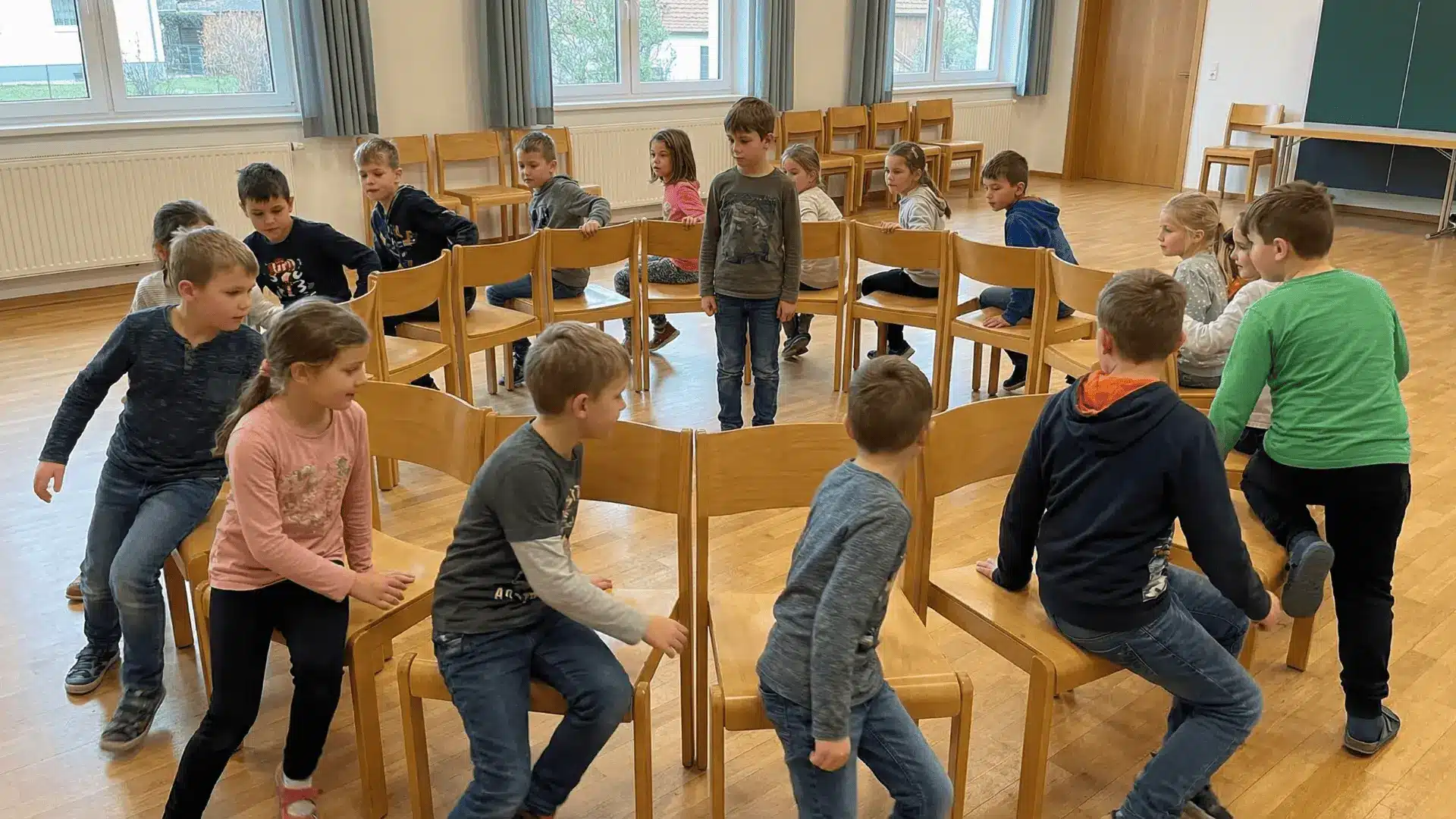 Children switching chairs in a circle while one child stands in the center
