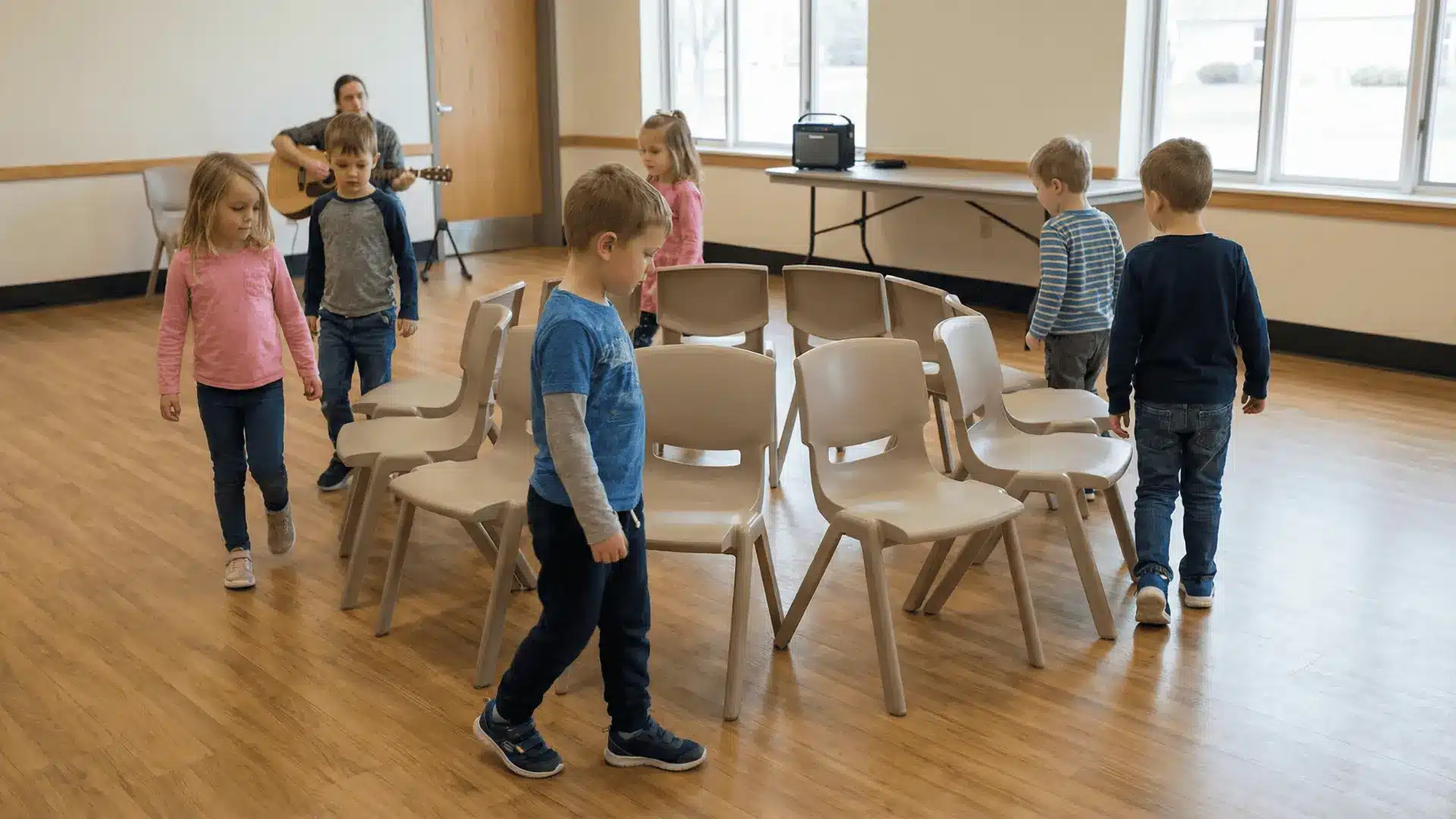 Children walking around chairs arranged in a circle