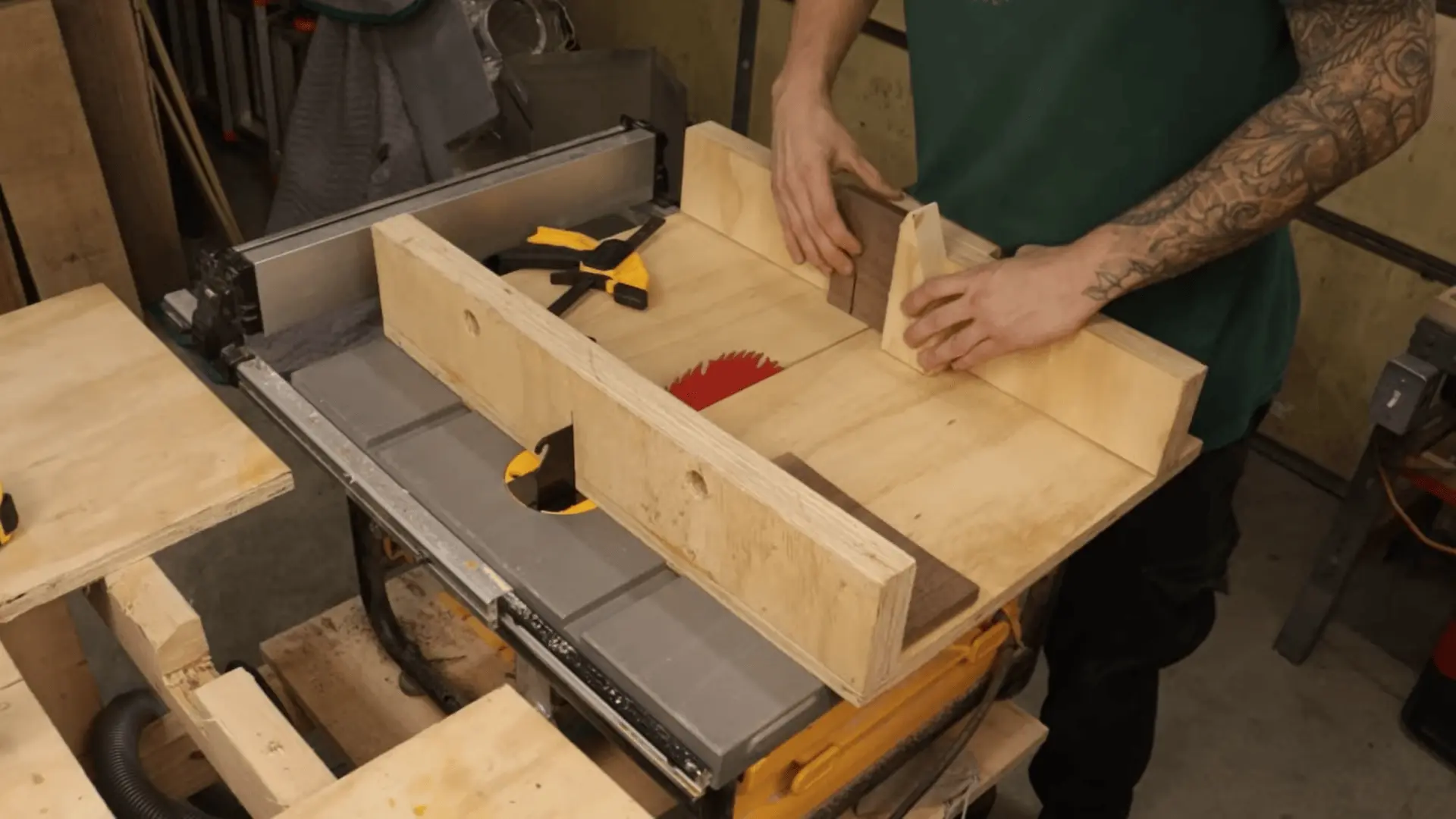 Cutting a slot in a wooden piece on a table saw using a jig to guide the workpiece safely