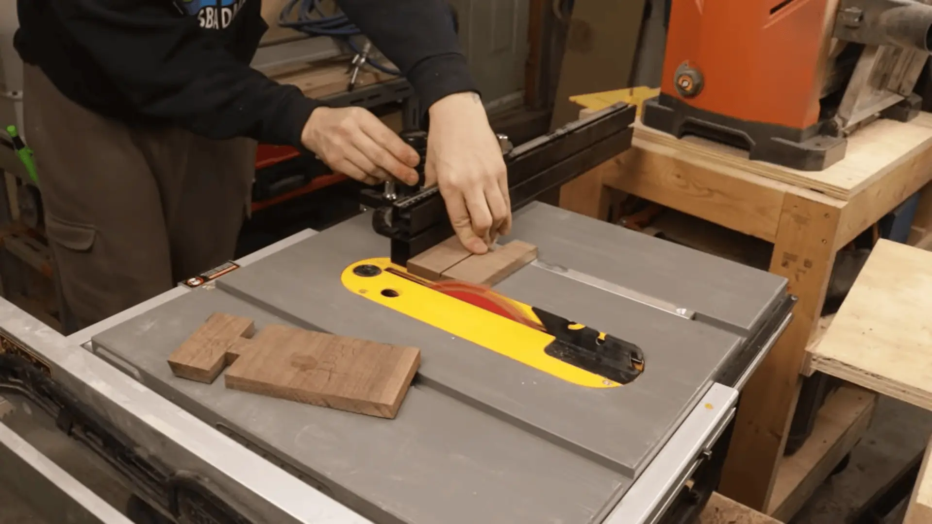Cutting angled edges on a wooden piece using a table saw and miter gauge for better stability