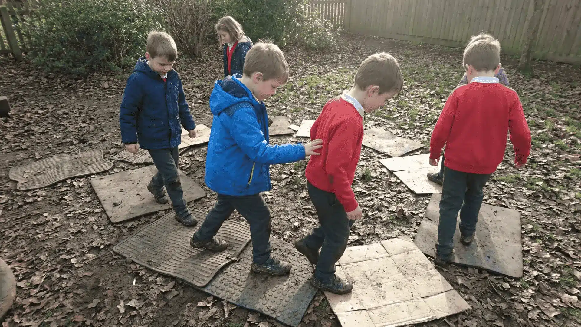 Kids stepping on mats to move across a space without touching the ground