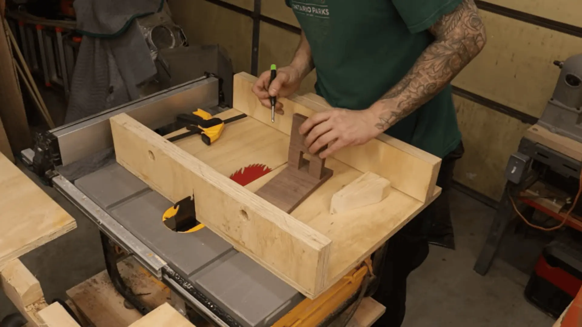 Marking and aligning the second wooden piece to match the slot position for a proper interlocking fit
