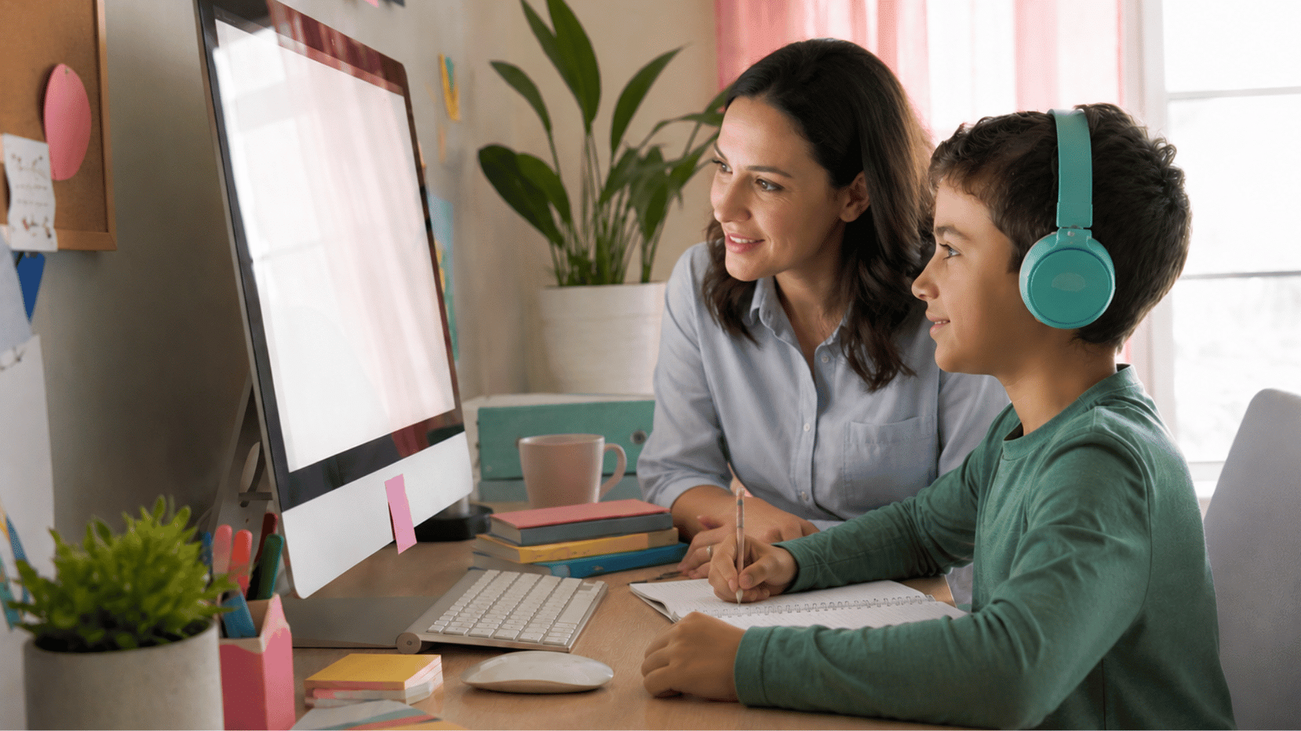 parent tracking homeschooling progress with notebooks and laptop inside home