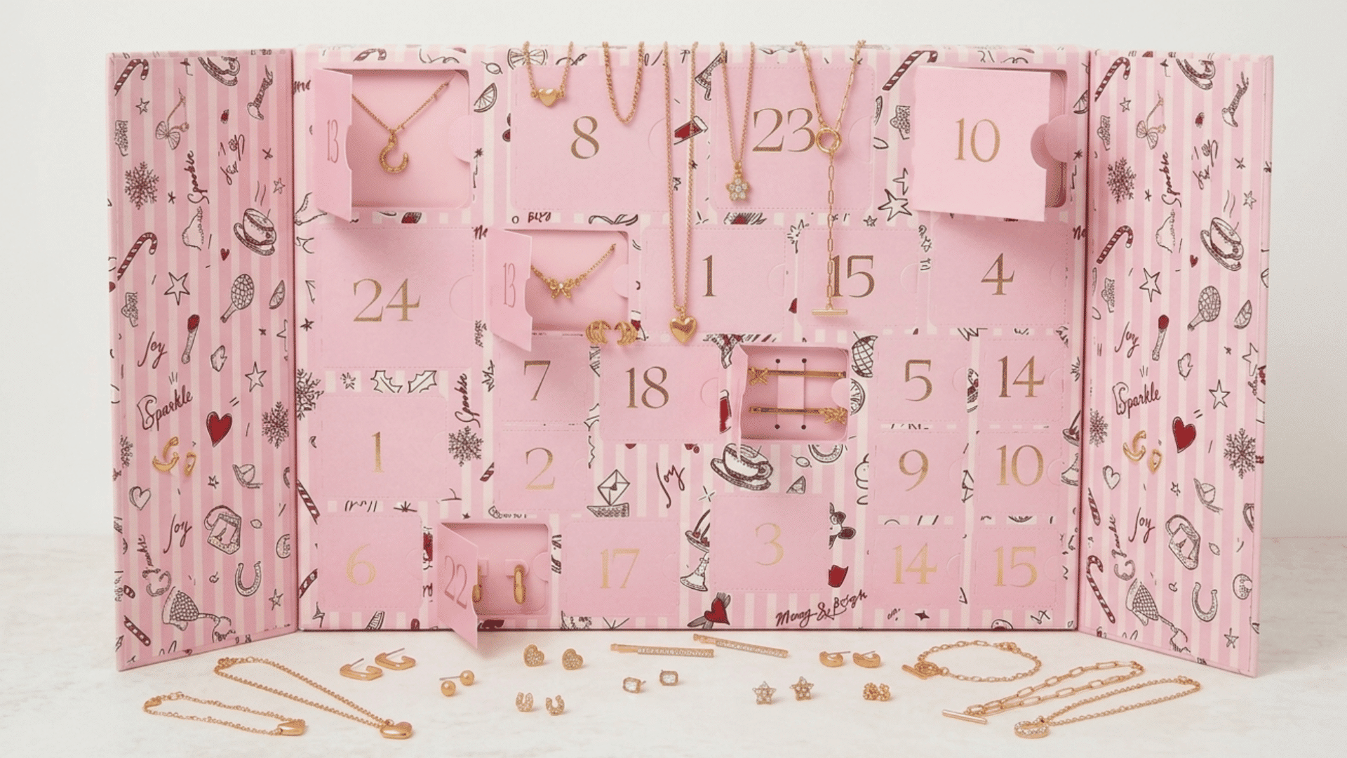 pink jewelry advent calendar with necklaces, earrings, bracelets, and stylish holiday accessories on display