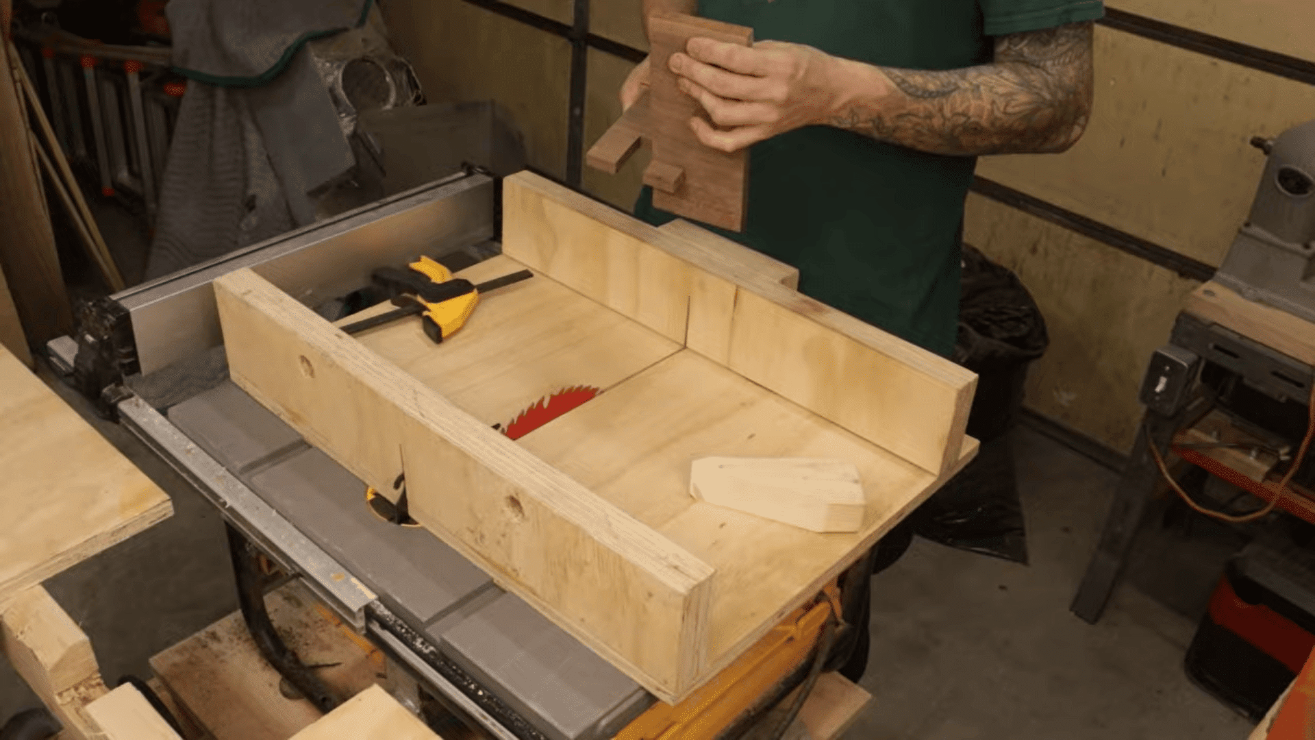 Testing and adjusting the slot fit between two wooden pieces to ensure a smooth and secure connection