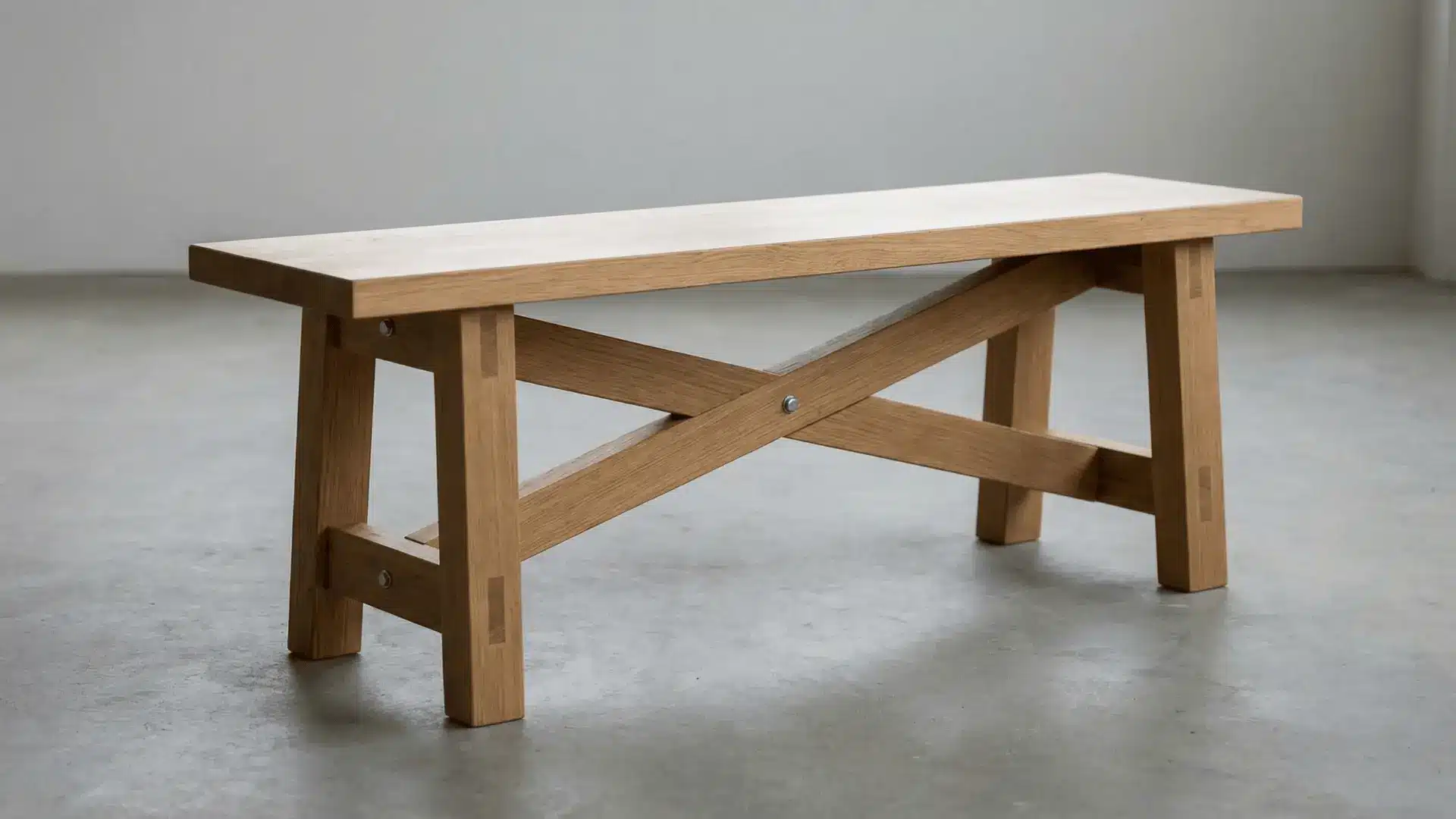 Wooden bench with reinforced supports between legs placed on a flat indoor floor