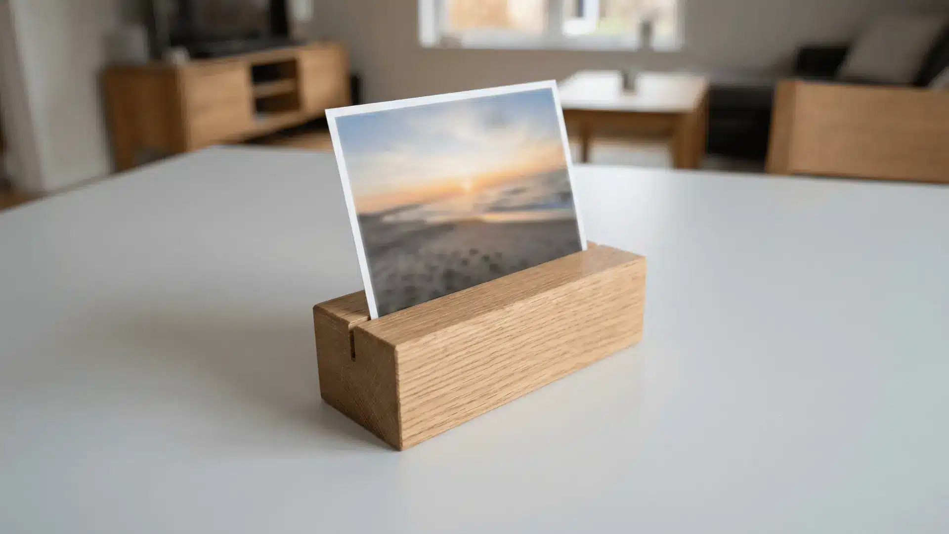 Wooden photo holder with a slot holding a photo upright on a flat surface