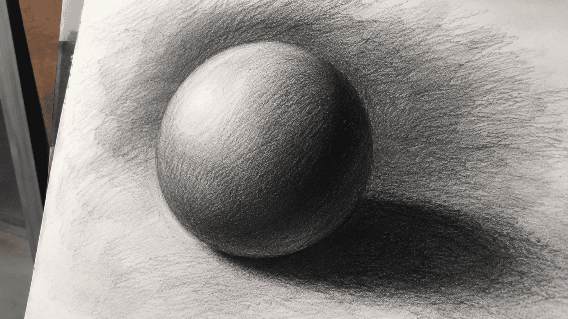 charcoal drawing of a shaded sphere showing full value range from bright highlight to deep shadow