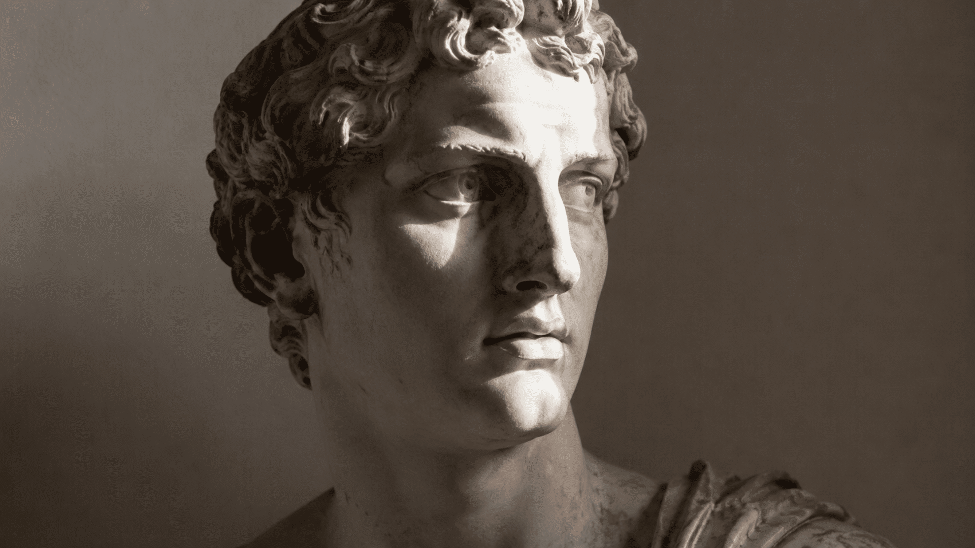 classical white marble bust sculpture with dramatic light and shadow showing three-dimensional form