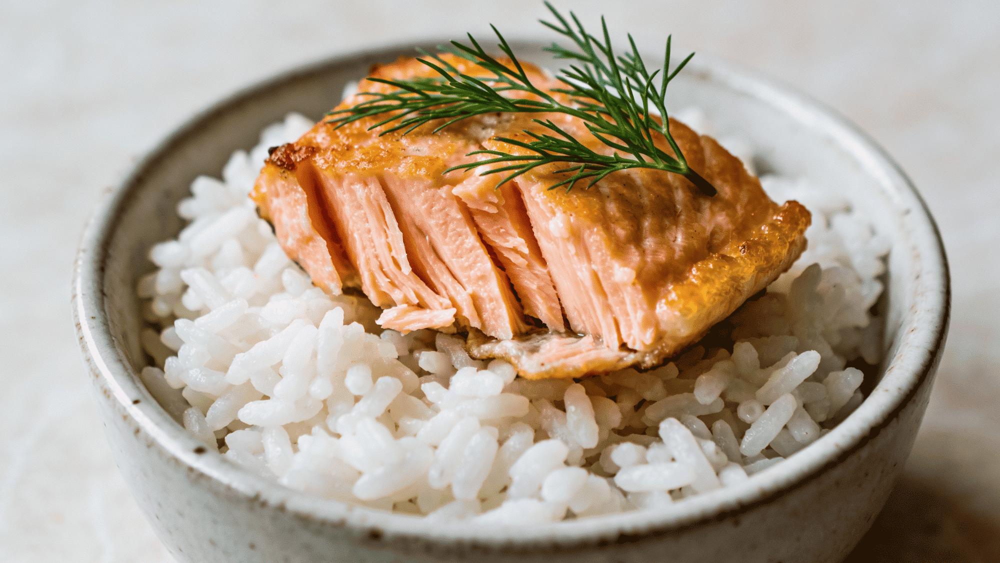 flaky pan-seared salmon bites with golden edges served over steamed white rice