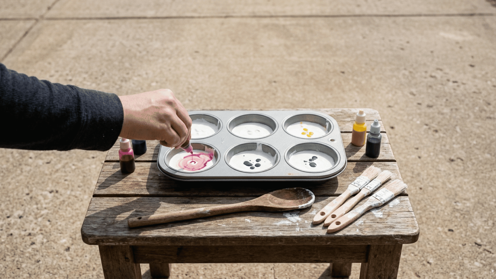 adding pastel colors to chalk paint mixture divided in muffin tray cups for a fun diy activity