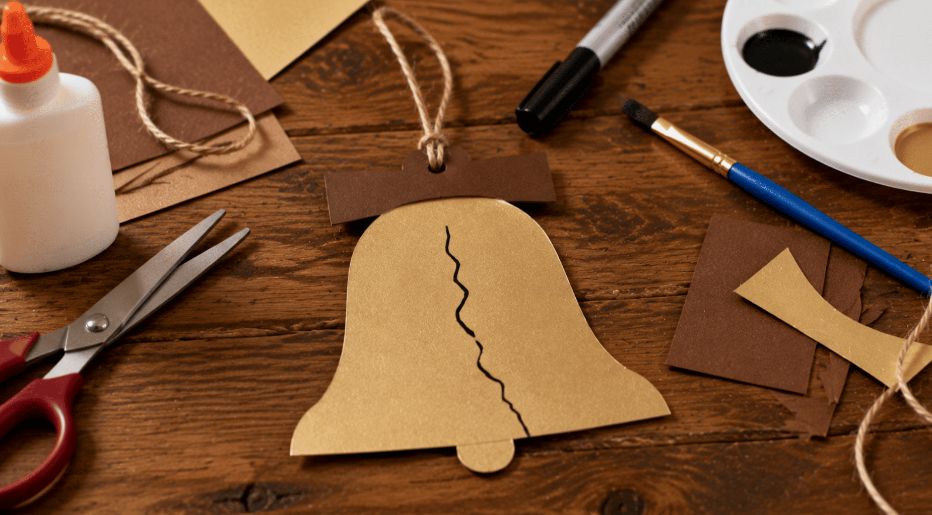realistic liberty bell paper craft with handmade details and craft tools
