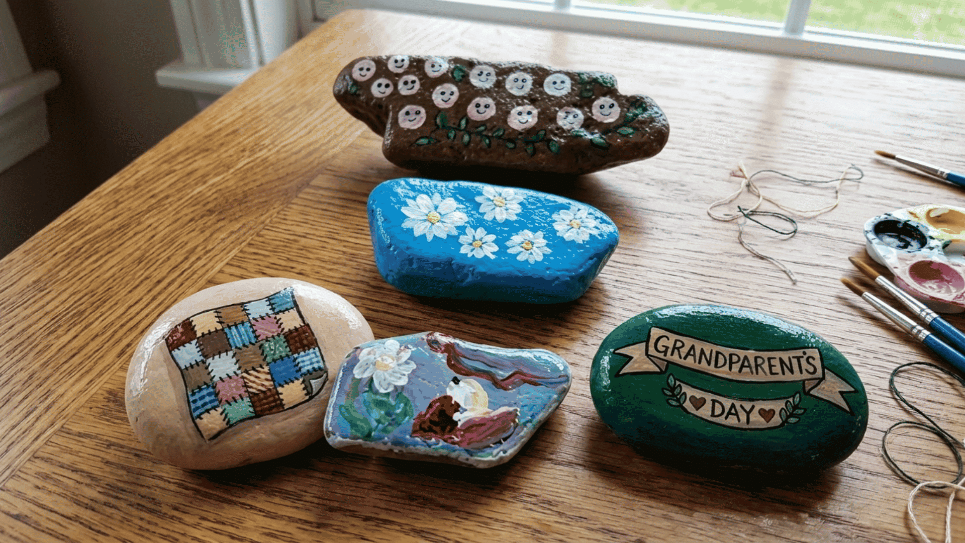 painted rock keepsake with colorful hearts flowers and a loving message displayed on a wooden table for grandparents