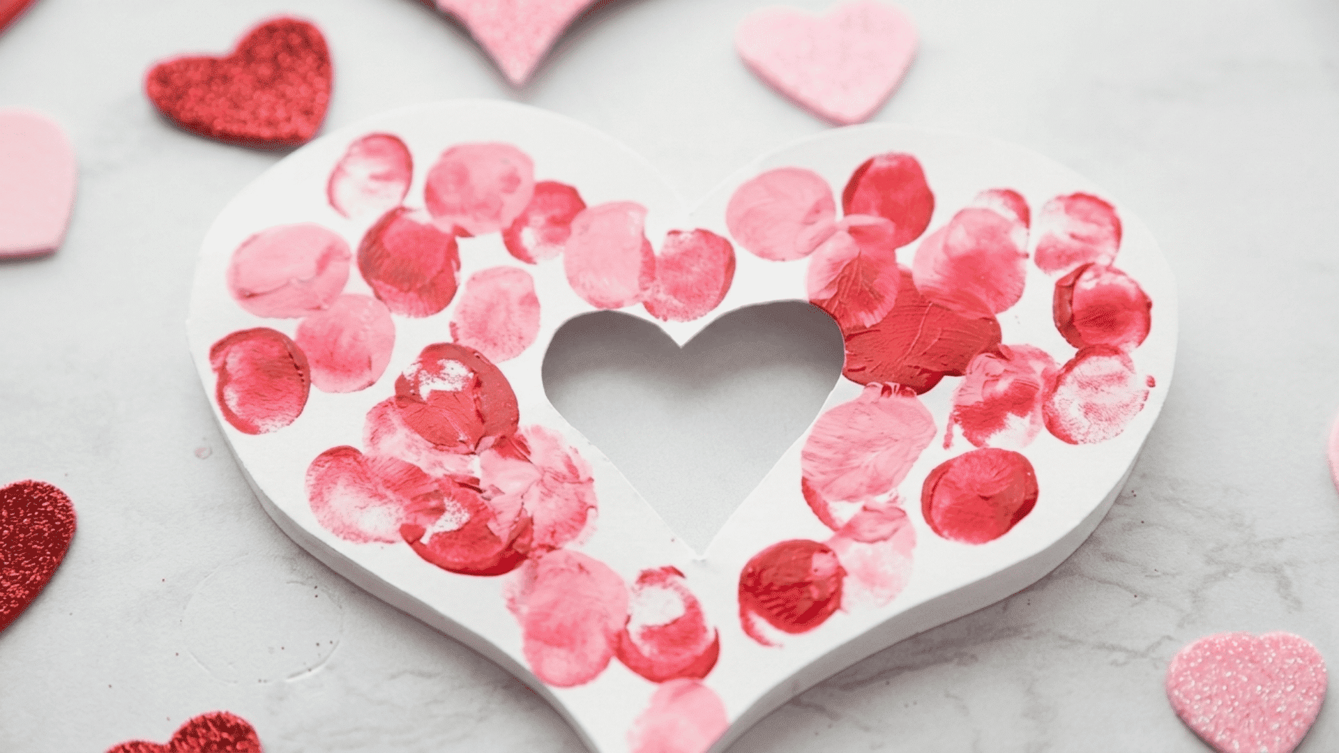 thumbprint heart card with colorful prints and a loving note made by a child for grandparents day